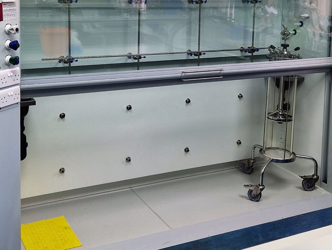 An empty fume cupboard inside of a laboratory.