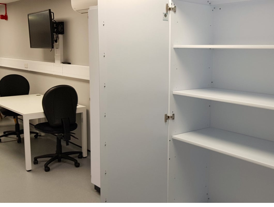 An office with a cupboard and office chairs.