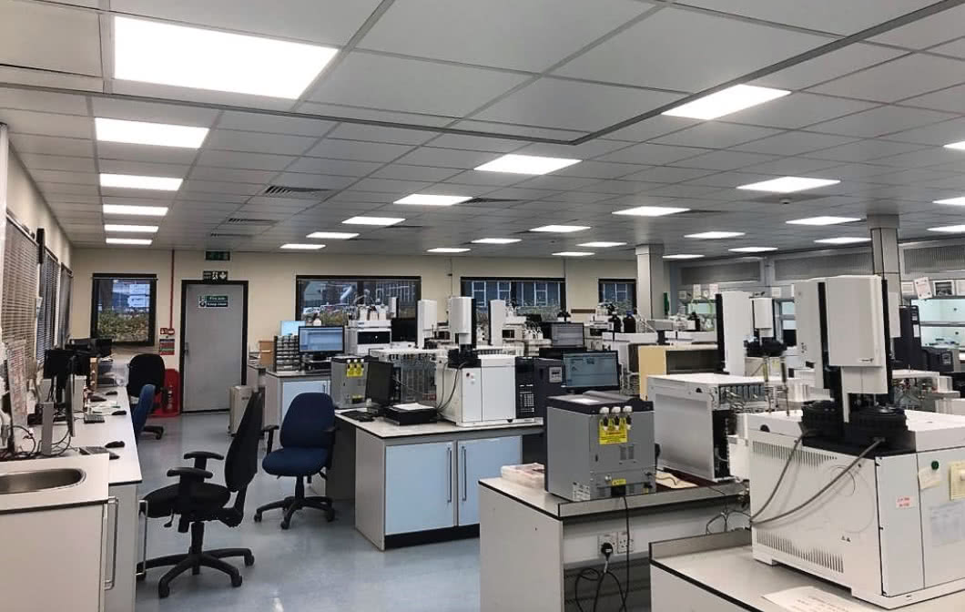 Laboratory room filled with desks, chairs, and lab equipment.