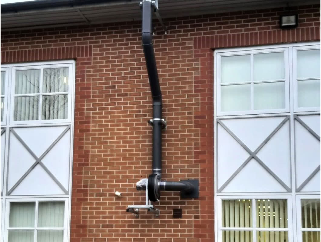 An extractor system on the side of a building.
