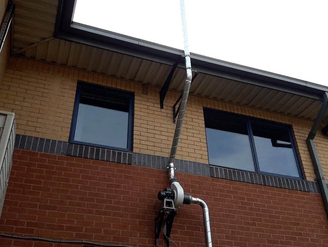 Another extractor fan on the side of a building.